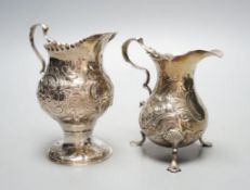Two 18th century silver cream jugs, with later embossed decoration, London, 1753 & London, 1770,