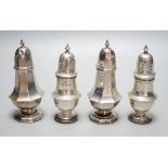 A pair of late Victorian silver panelled pepperettes, London, 1900 and a later pair, London, 1931,