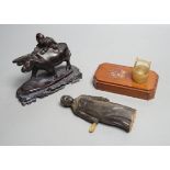 A Chinese horn figure and a carved hardwood figure riding a buffalo,13 cms wide.