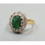 A yellow metal, emerald and diamond set oval cluster ring, size P/Q, gross weight 5 grams.