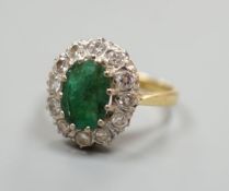 A yellow metal, emerald and diamond set oval cluster ring, size P/Q, gross weight 5 grams.