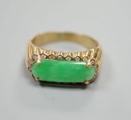 A yellow metal, jadeite and diamond set ovoid dress ring, size T, gross 6.6 grams.