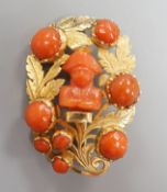A 19th century yellow metal and coral set foliate brooch, the central motif carved as the bust of