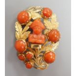 A 19th century yellow metal and coral set foliate brooch, the central motif carved as the bust of