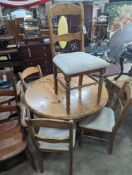 A reproduction circular pine breakfast table, diameter 105cm, height 77cm together with five pine