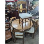 A reproduction circular pine breakfast table, diameter 105cm, height 77cm together with five pine