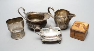 A late Victorian silver cream jug, London, 1900, a German 800 cream jug, a silver mustard pot, two