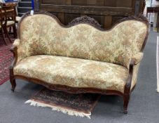 A Victorian upholstered carved rosewood double spoonback settee, width 176cm, depth 74cm, height