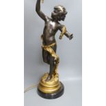 A gilt and brown patinated spelter putto lamp with flame glass shade, signed Moreau