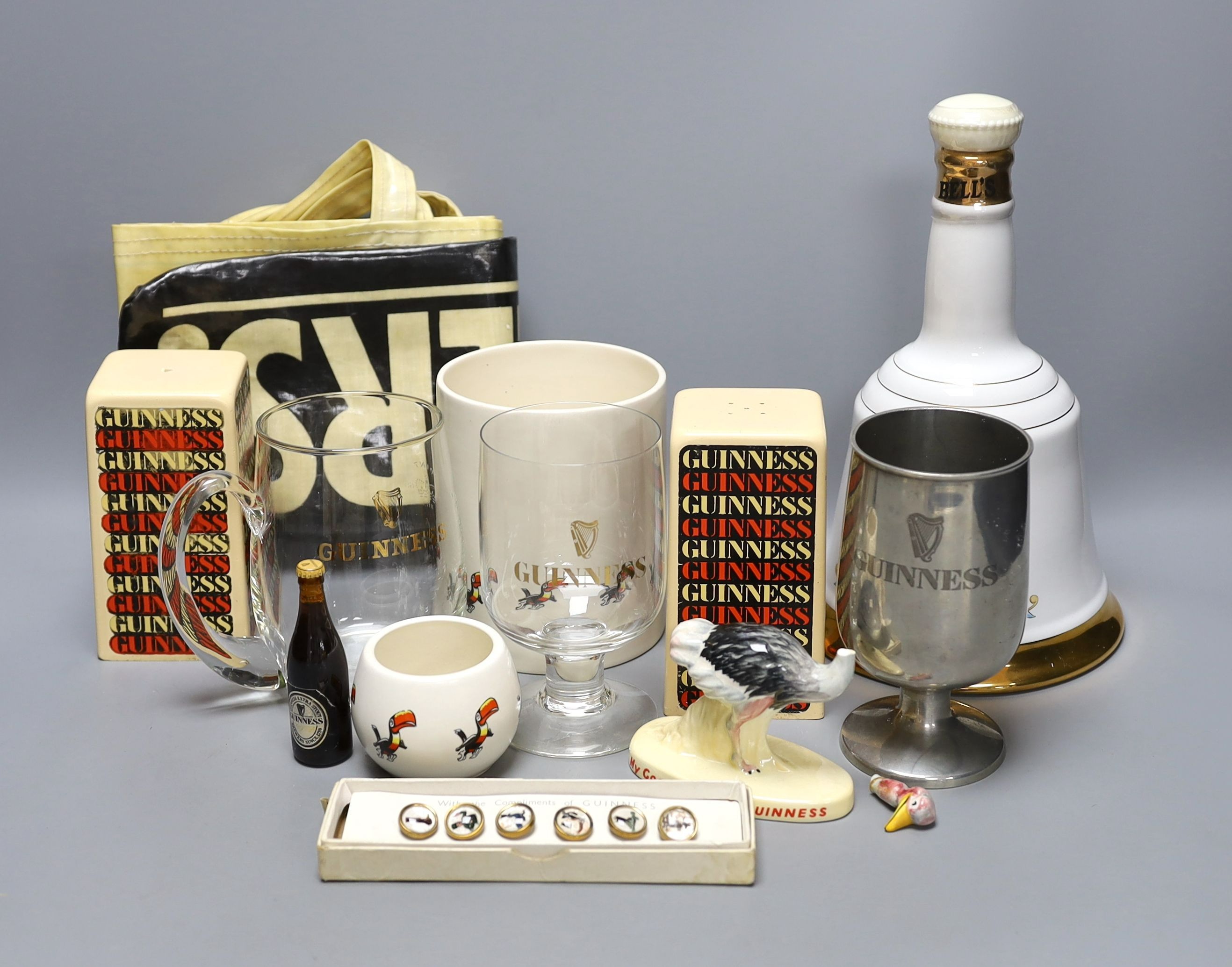 Assorted Guiness memorabilia, a Bells porcelain bottle of whisky, commemorative to the 60th birthday
