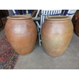 A pair of large terracotta garden planters, height 88cm