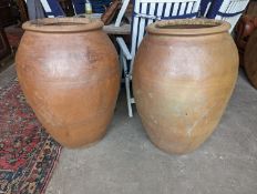 A pair of large terracotta garden planters, height 88cm