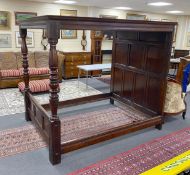 An 18th century style oak four poster bed with panelled canopy, width 162cm, length 221cm, height