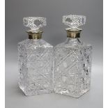 A pair of silver mounted cut glass decanters and stoppers, 23.5cm