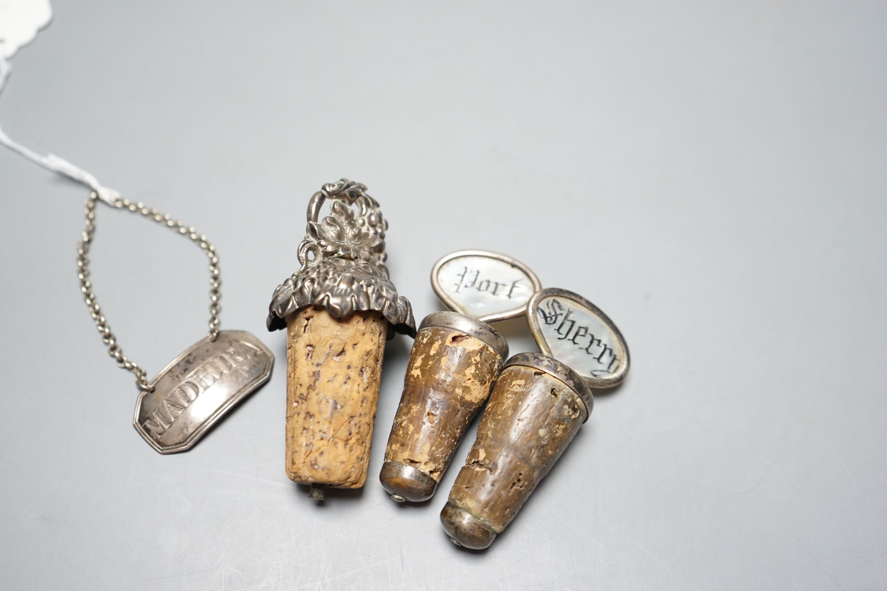 A George III silver 'Madeira' wine label, London, 1803 and three mounted cork bottle stoppers. - Bild 2 aus 2