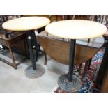 A pair of circular beech and iron pub tables, diameter 74cm, height 104cm
