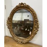 An oval giltwood and gesso wall mirror, width 89cm, height 108cm