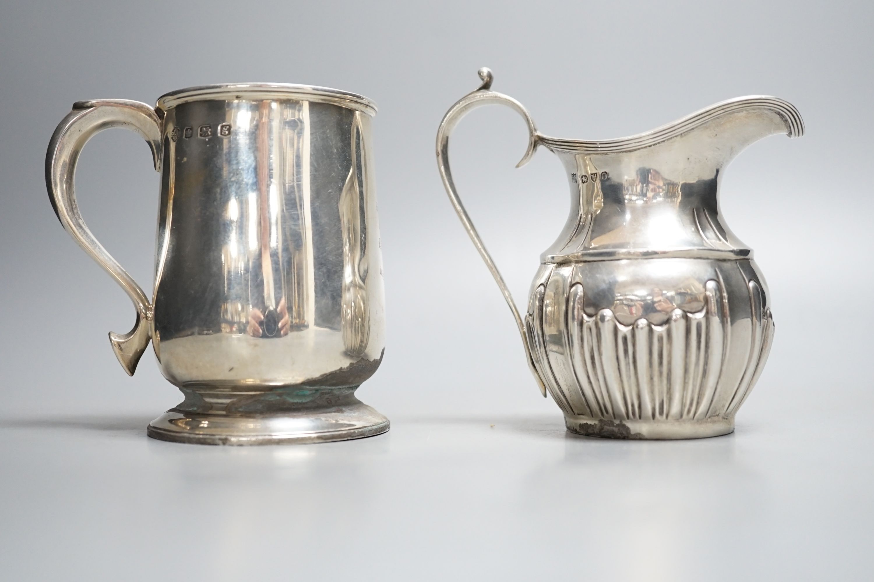 A late Victorian silver cream jug, Nathan & Hayes, Chester, 1897 and a George V silver christening - Image 3 of 4