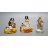 A pair of Staffordshire porcellaneous groups of children with a King Charles spaniel and a figure of