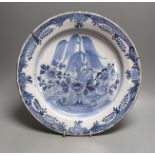 An 18th century Delft blue and white dish with central flower - 36cm diameter