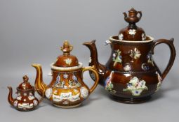 A Victorian Measham Bargeware pottery tea pot and cover, 29cm high and two similar reproduction