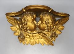 A giltwood cherub bracket 51cm wide