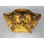 A giltwood cherub bracket 51cm wide