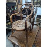 A near pair of early 20th century beech bentwood childs elbow chairs