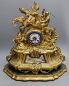 A 19th century gilt spelter mantel clock, having horse and jockey surmount with porcelain panels and