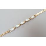 A modern gilt metal and five stone oval white opal set bracelet, 16.5cm.