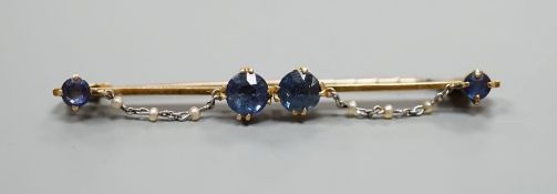 An early 20th century yellow metal sapphire and seed pearl set bar brooch, 61mm, gross weight 5.6