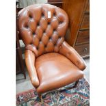 A modern buttoned brown leather easy chair, width 64cm, depth 70cm, height 85cm