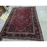 A Caucasian design burgundy ground carpet, 280 x 210cm