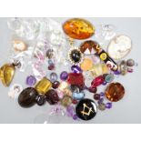 A quantity of assorted unmounted cut gemstones including small diamonds and other minor jewellery.