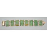 A 585 yellow metal and jade bracelet, set with eight rectangular panels, 18cm, gross weight 26.5