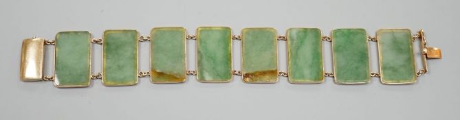 A 585 yellow metal and jade bracelet, set with eight rectangular panels, 18cm, gross weight 26.5
