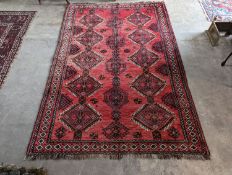 A Caucasian style red ground rug, 255 x 167cm