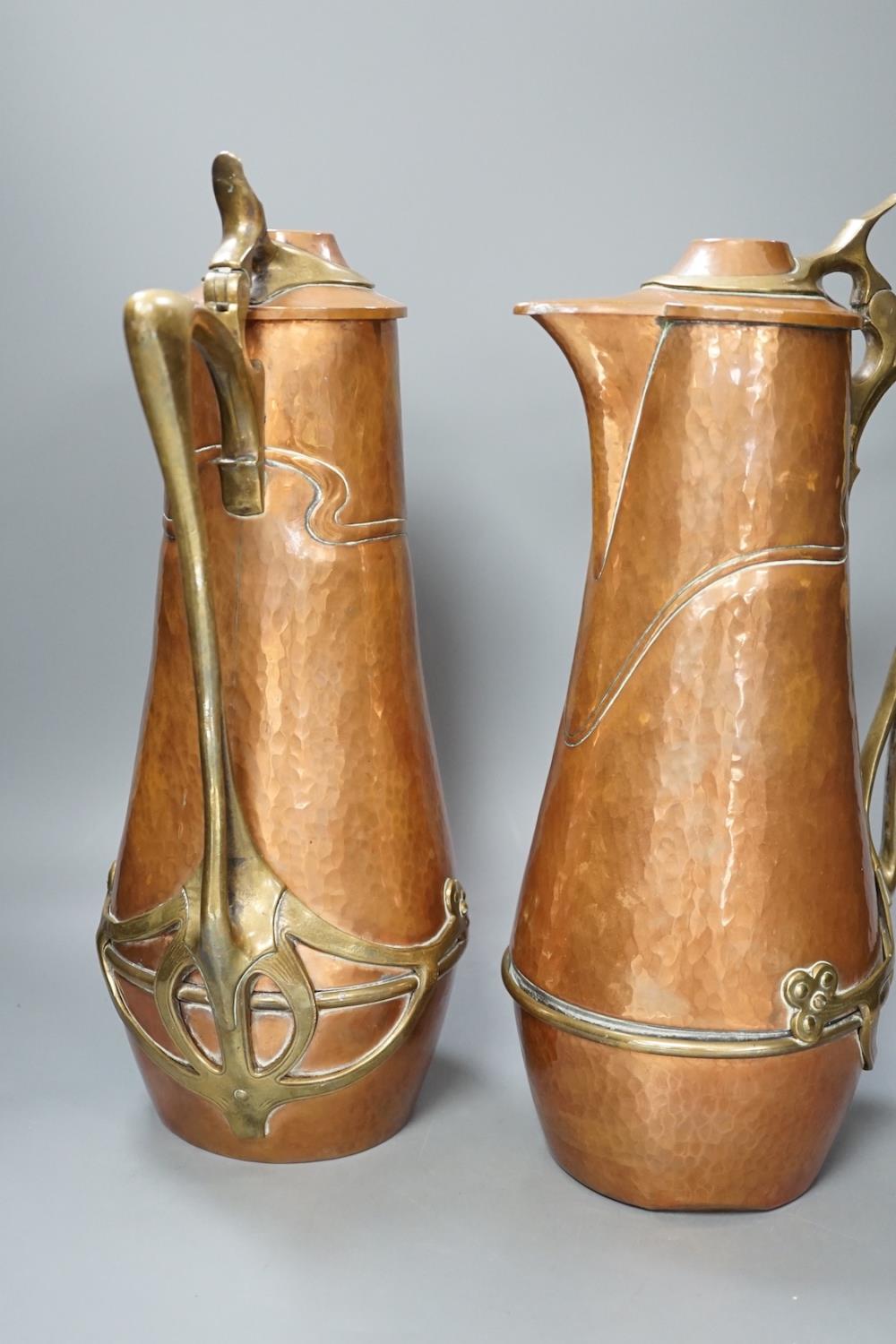 A pair of German or Austrian Jugendstil copper and brass jugs, 38cm - Image 6 of 6