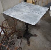 A reconstituted marble and cast iron garden table, width 60cm height 73cm