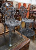 A painted aluminium circular garden table and two chairs, table diameter 59cm height 68cm