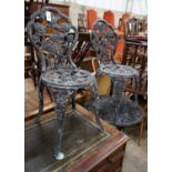 A painted aluminium circular garden table and two chairs, table diameter 59cm height 68cm