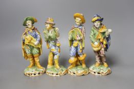 A set of four 19th century faience figures of street peddlers or performers - 18cm tall