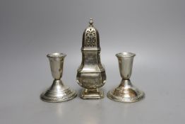 A modern pair of sterling mounted dwarf candlesticks, 92mm and a George V silver sugar caster, 16.