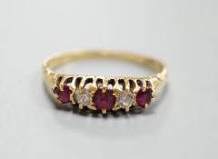 An 18ct three stone ruby and two stone diamond set half hoop ring, size P, gross 2.9 grams.