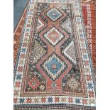 A Caucasian red ground rug, 230 x 128cm