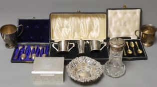 A group of mixed silver, including a cigarette box, two silver christening mugs, two similar pierced