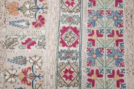 A 19th century Greek Islands polychrome silk embroidered runner on cram linen, with silk and linen