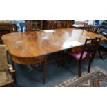 A George III mahogany D end extending dining table and six reproduction Chippendale style mahogany