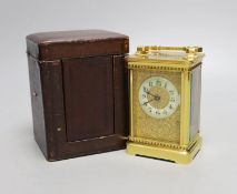 A cased French gilt brass carriage timepiece with relief cast dial and engraved presentation