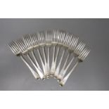 A set of twelve late George III silver Old English feather edge pattern table forks, indistinct